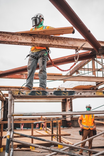 A worker helps with new technology on a construction job site